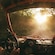Two Guests in a dune buggy driving on a dirt path through the woods